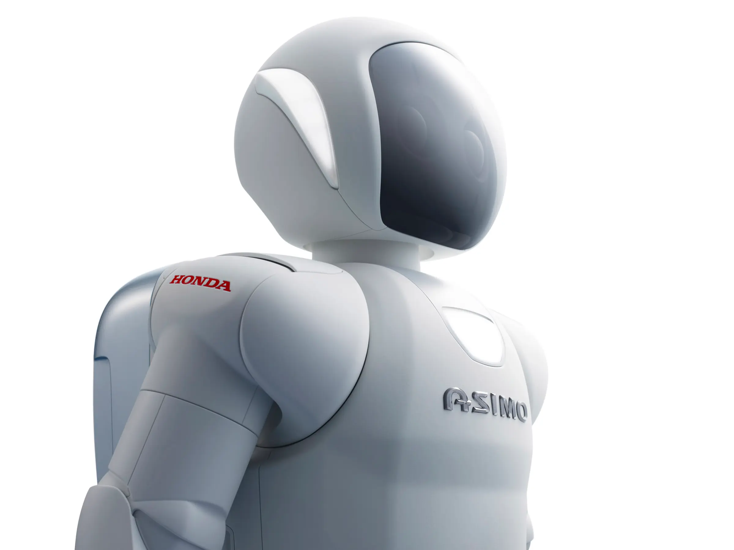 Japanese humanoid robot Asimo looks to the right of the frame with a dreamy look on its face.