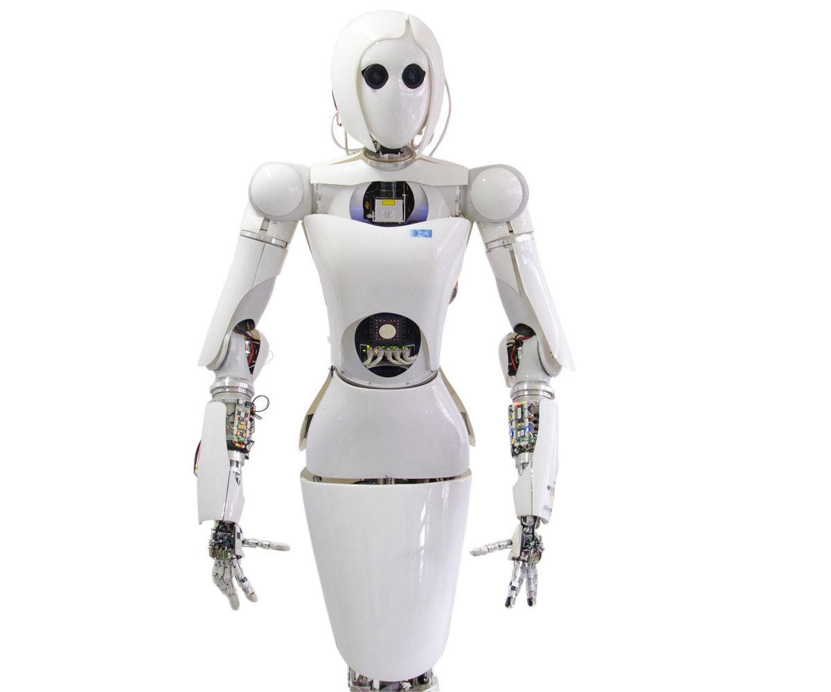 Humanoid robot Aila, with a mechanical body covered by white plastic casings, looks forward.