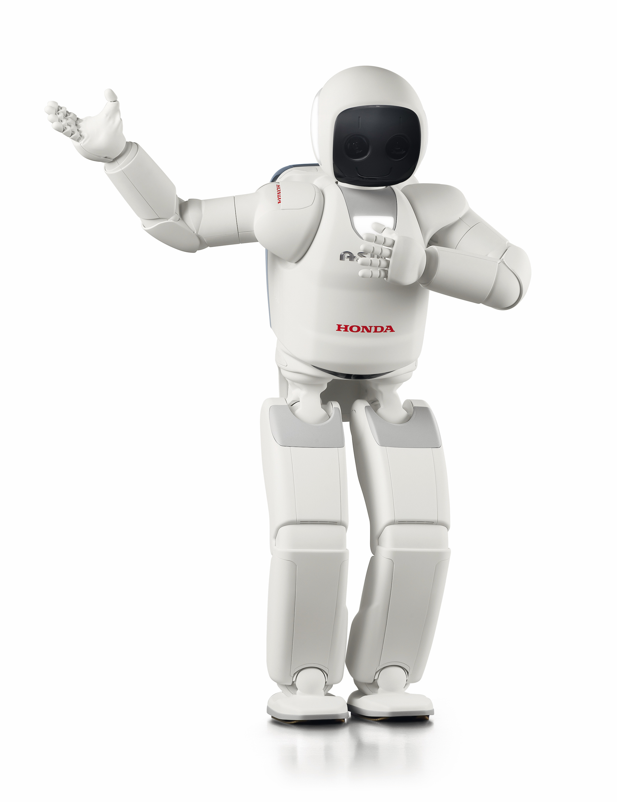 Japanese humanoid Asimo, with a white body that looks like an Astronaut suit, places one hand over its chest while lifting the other as if saluting an audience. 