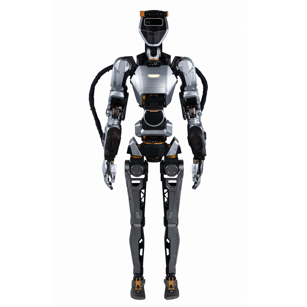 A humanoid robot about the size of an adult person, with a light gray and orange body, stands facing forward.